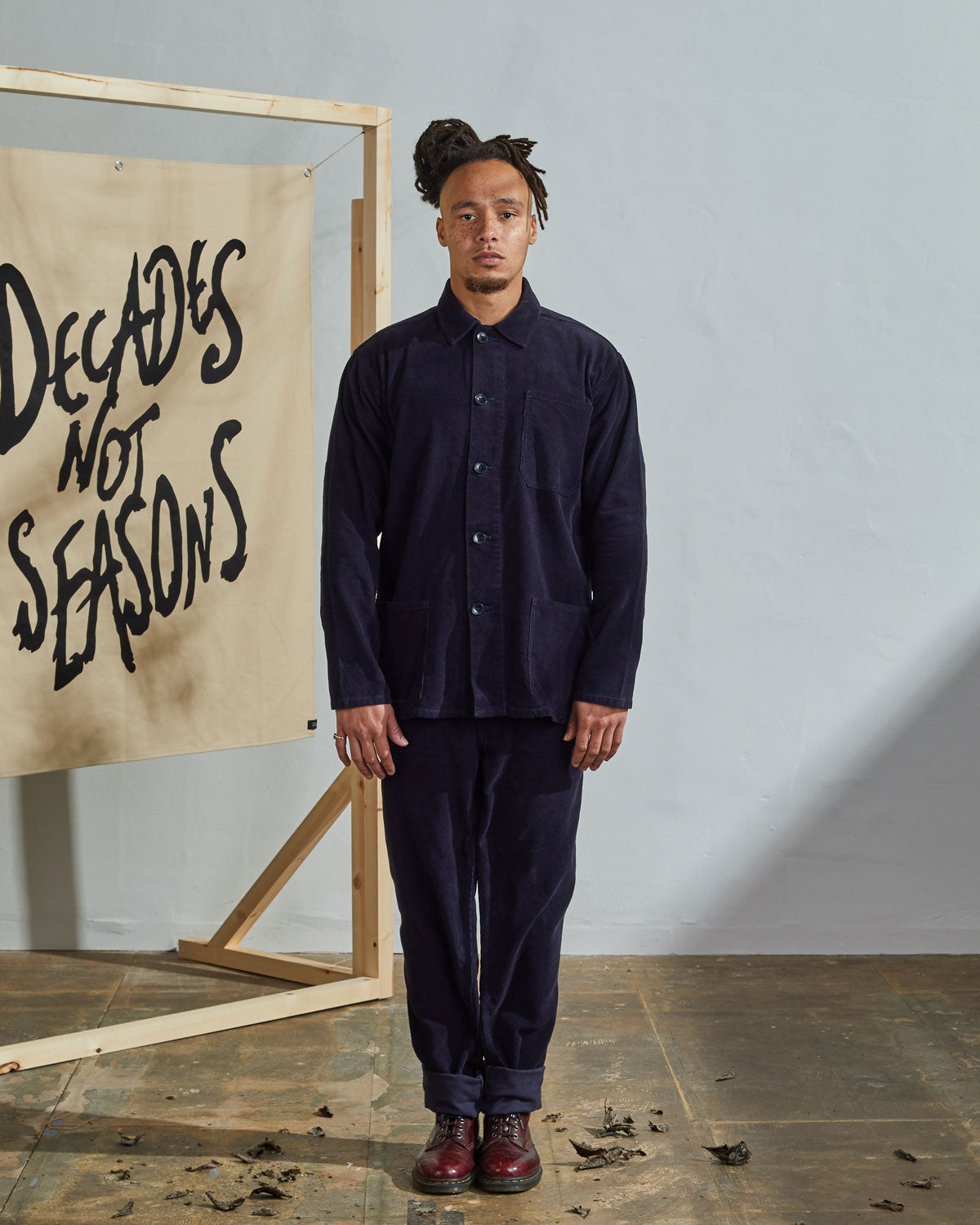 Full-length front view of model wearing unfastened #3001, midnight-blue corduroy overshirt paired with matching Uskees midnight blue cord pants.