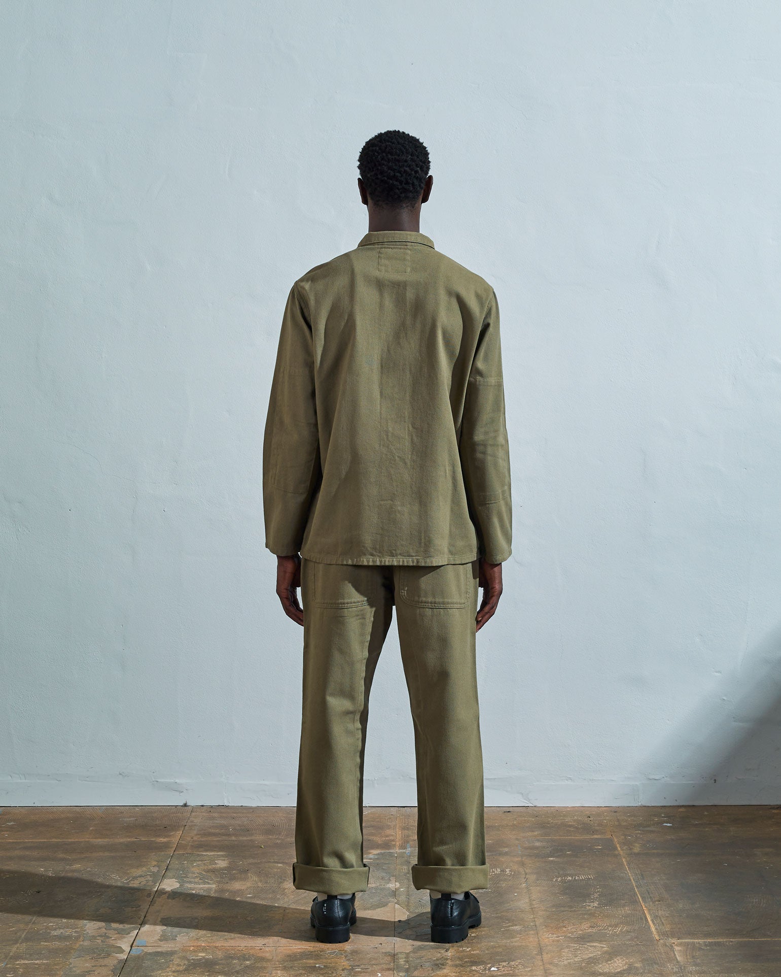 Full-length rear view of #3001, moss-green-coloured organic cotton-drill over shirt with reinforced elbows.