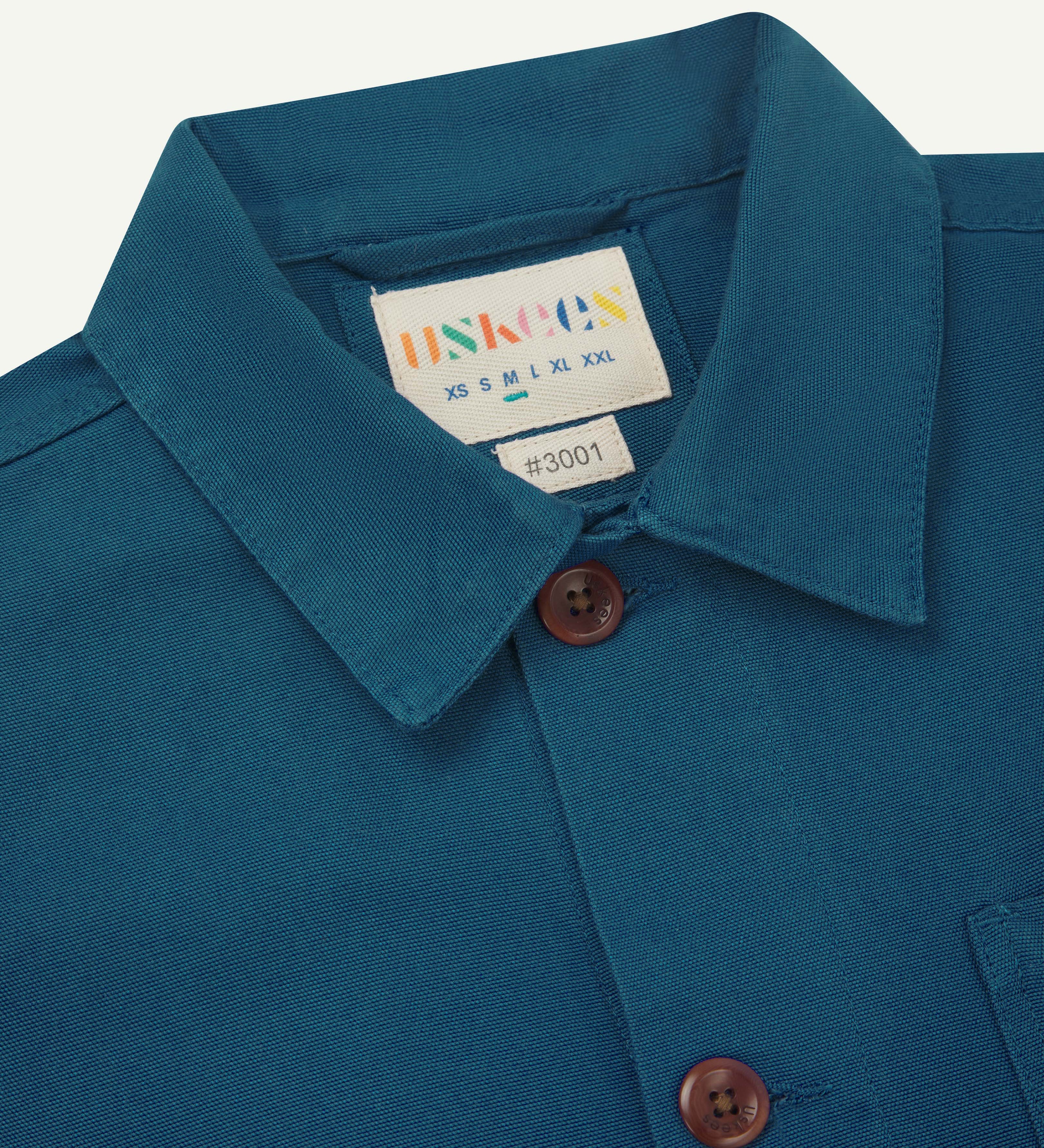 Close up shot of uskees peacock blue #3001 overshirt for men showing collar and front buttons
