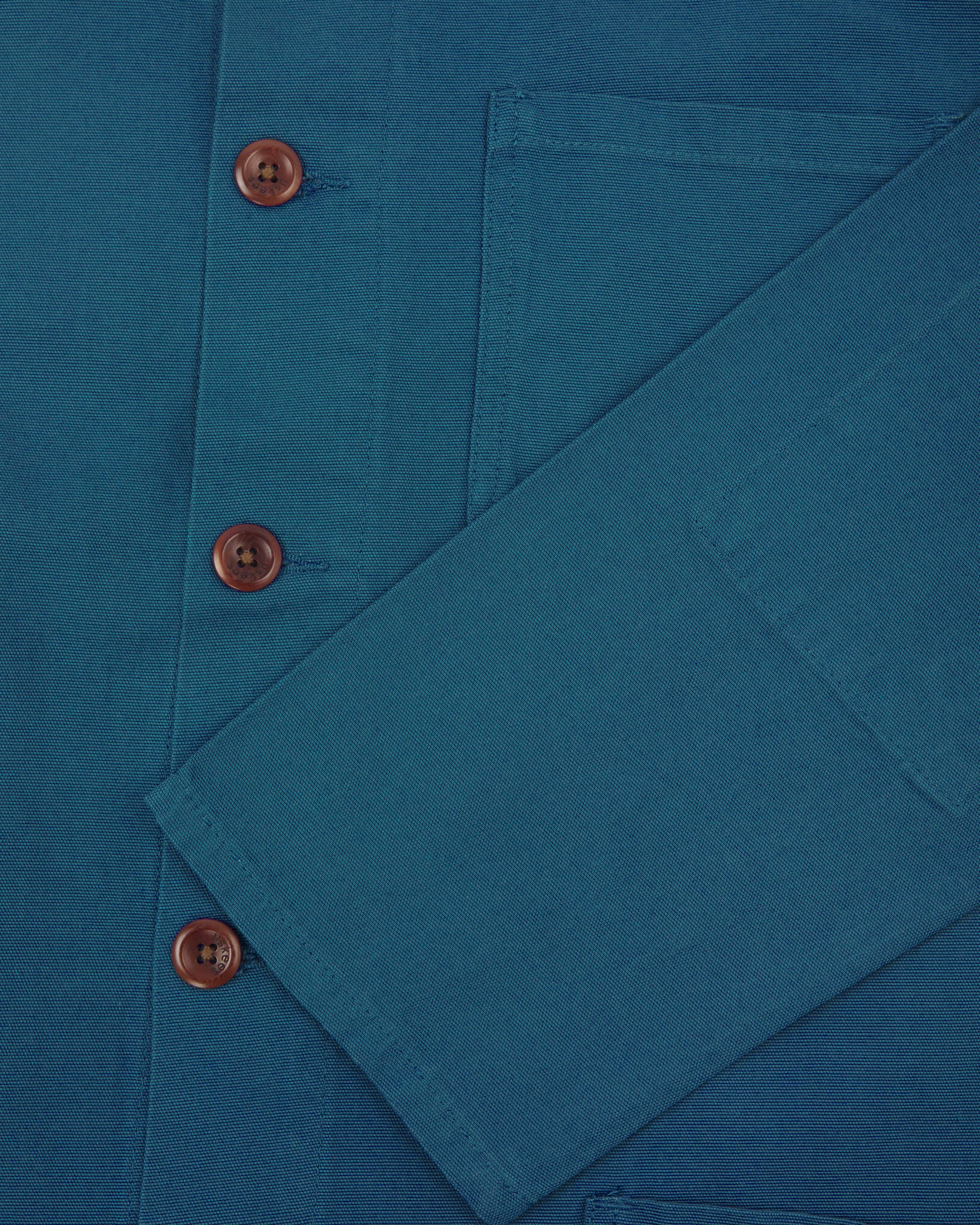 Close up detail shot of uskees peacock blue overshirt showing sleeve and front corozo buttons
