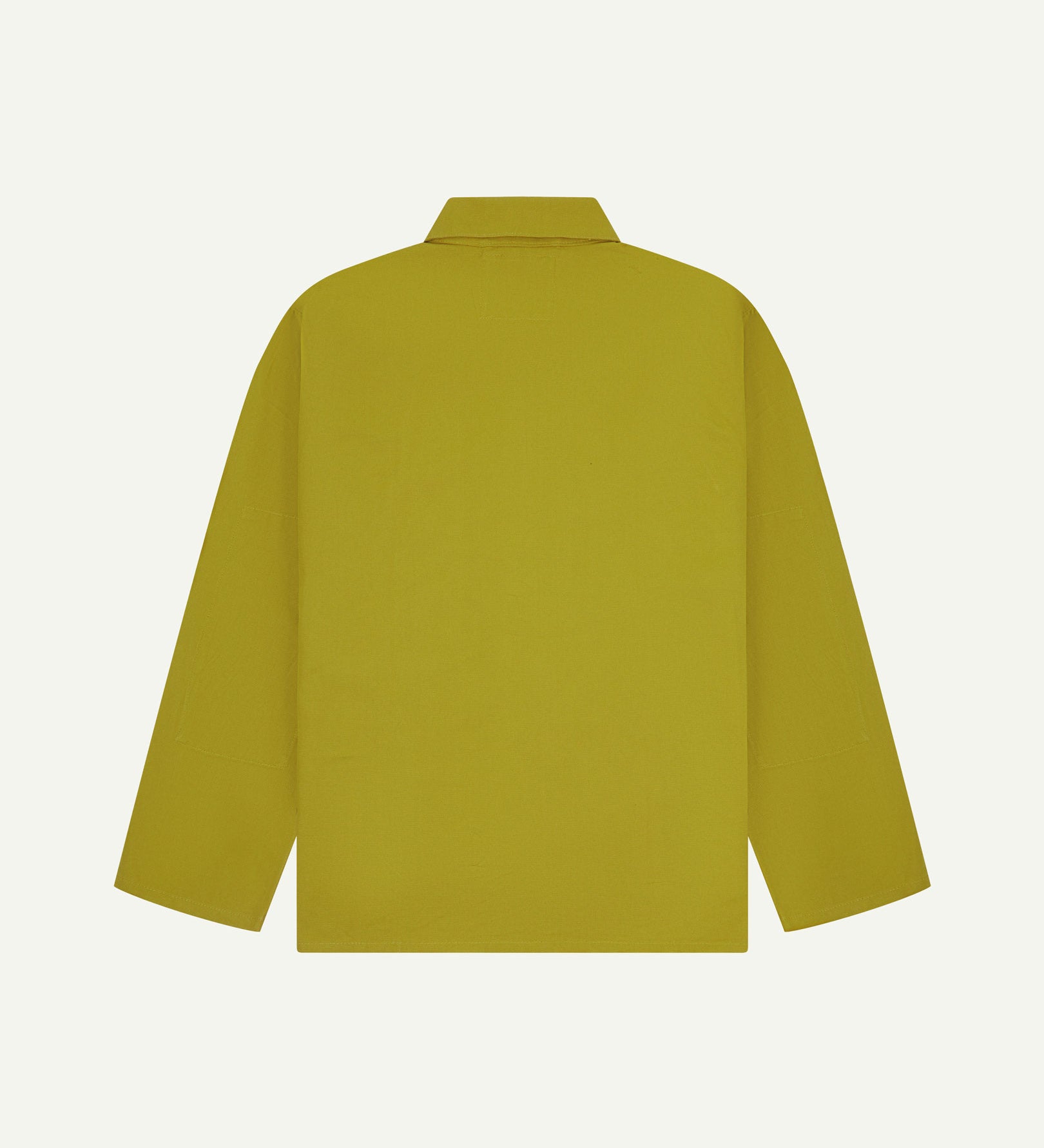 Reverse of yellow-green pear-coloured buttoned organic cotton drill overshirt from Uskees. Showing reinforced elbows and boxy silhouette.