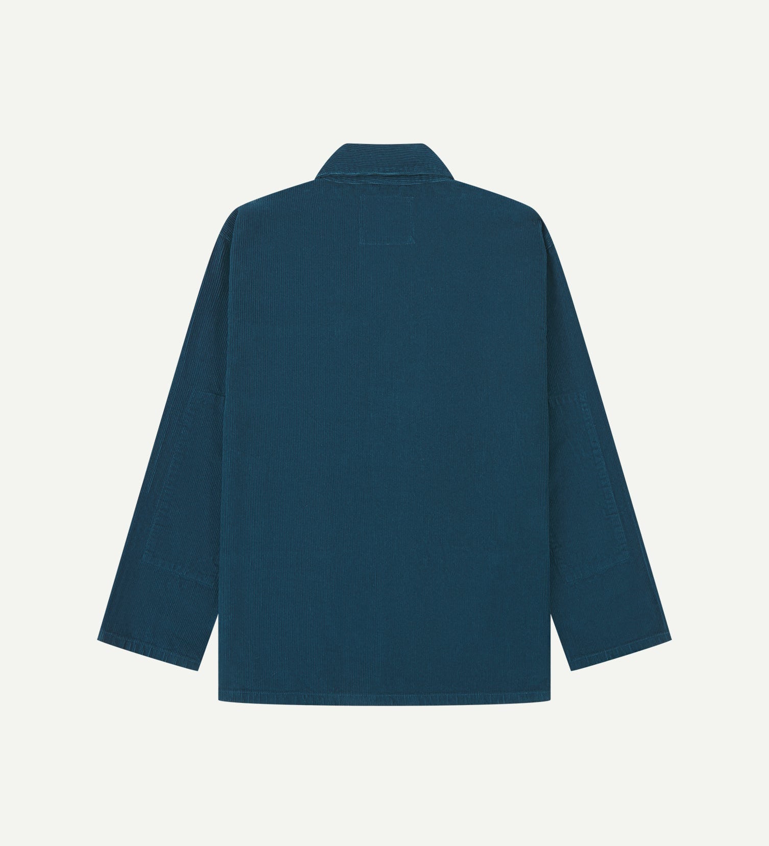 Back view of petrol blue, buttoned corduroy overshirt with view of reinforced elbow area and boxy silhouette.
