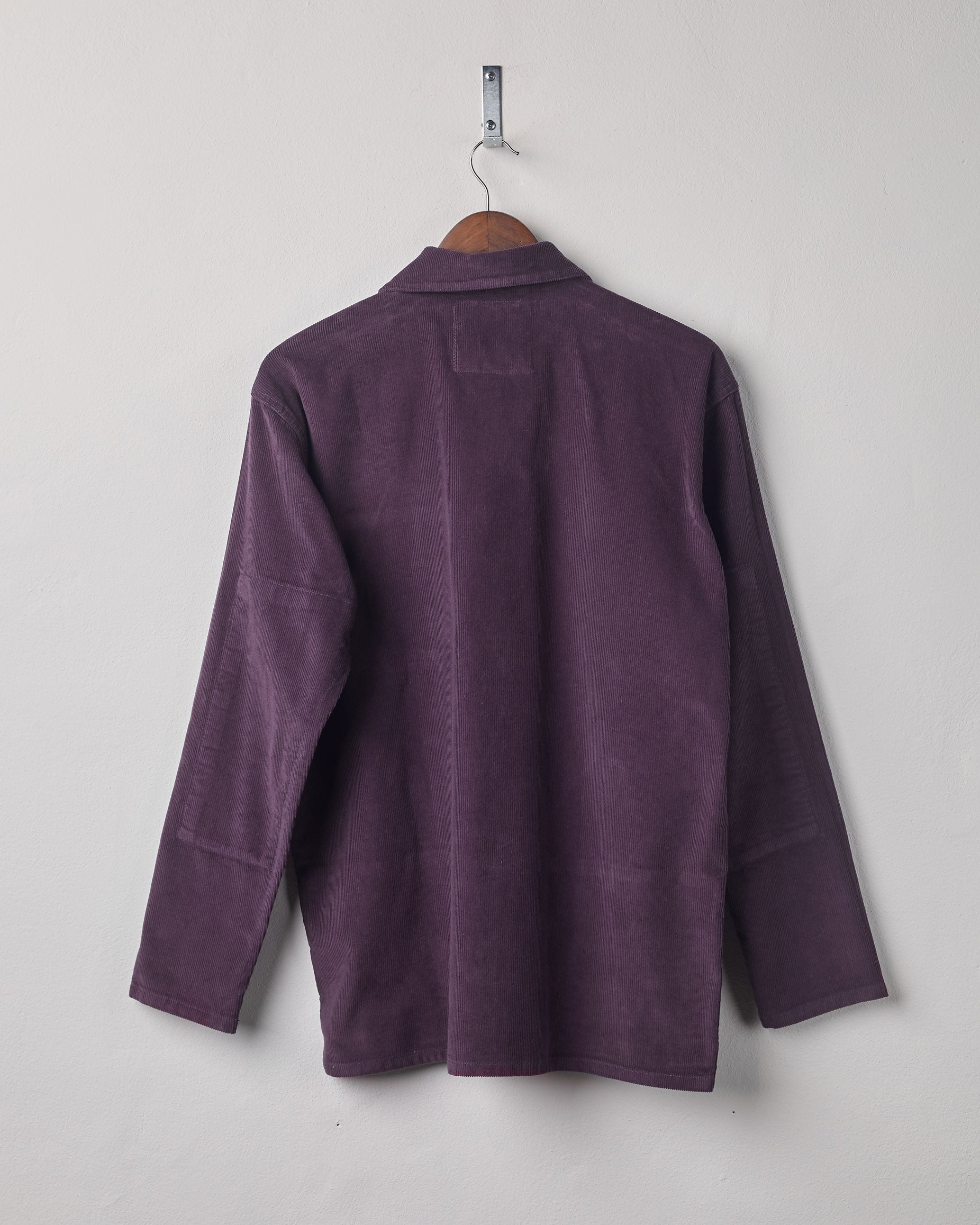 Full-length rear view of #3001, plum-coloured corduroy over shirt with reinforced elbows.
