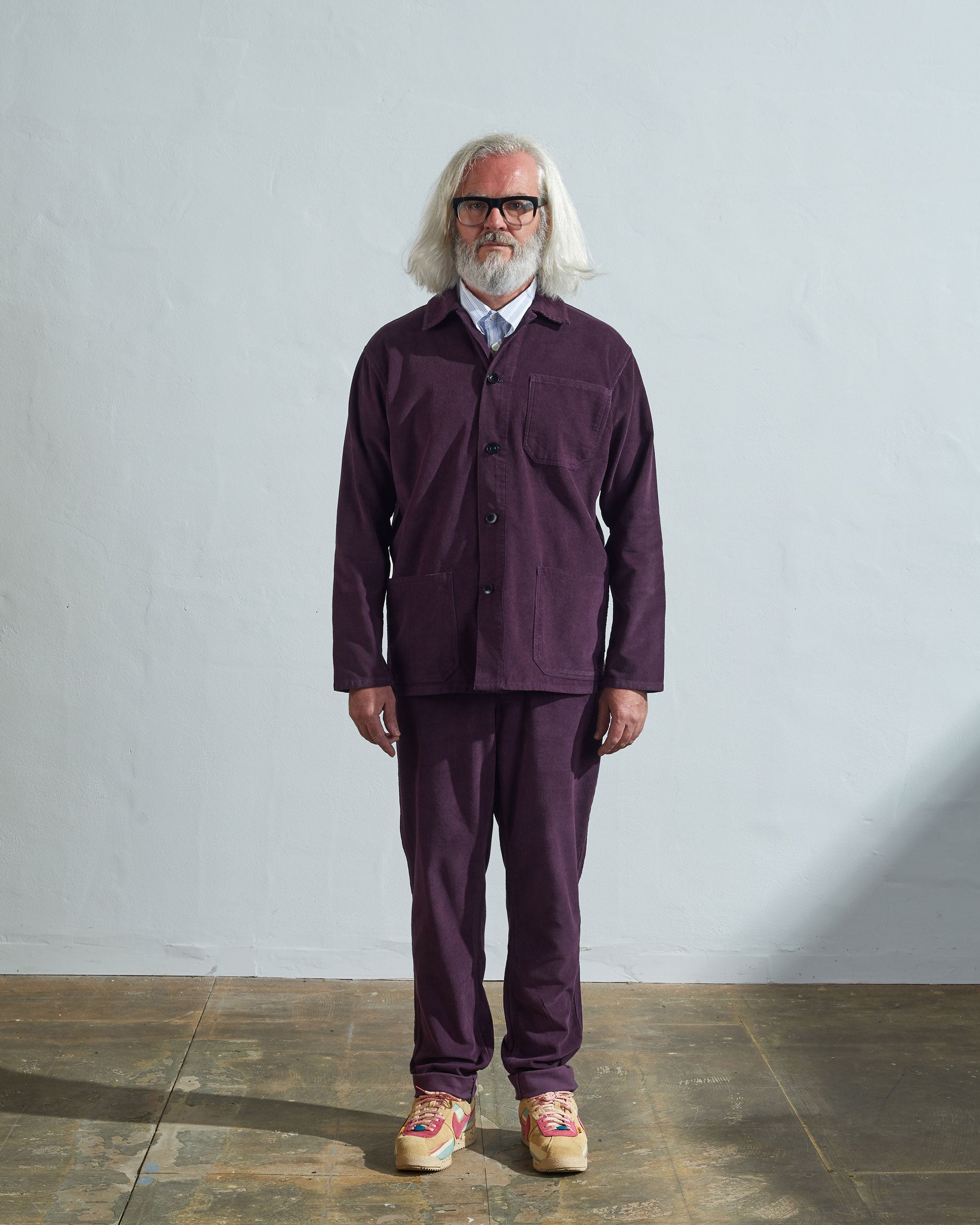 Full-length front view of model wearing #3001, plum corduroy overshirt paired with matching Uskees plum cord pants.