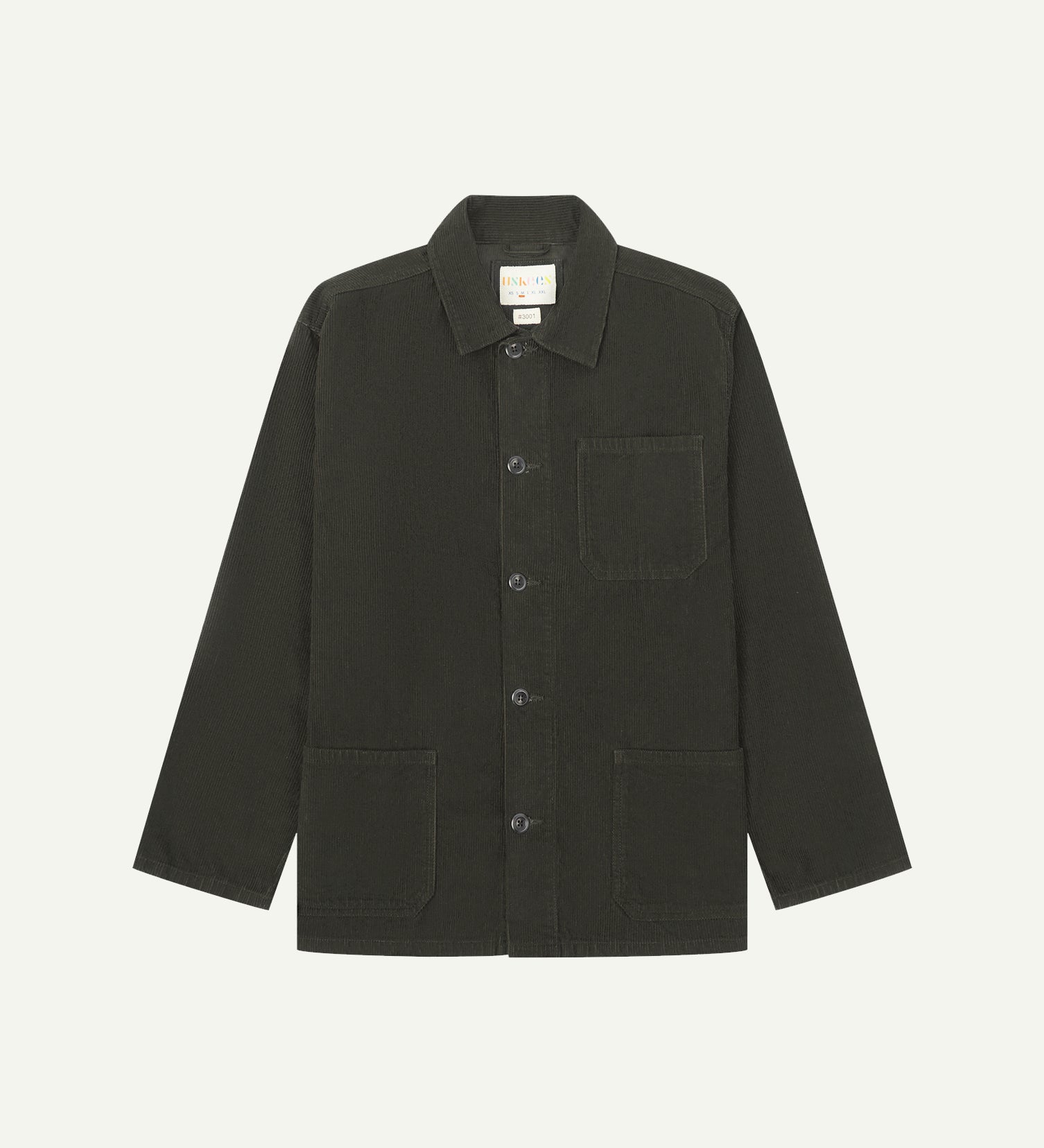 Front flat shot of green-brown (seaweed), buttoned corduroy overshirt. Clear view of chest and hip pockets, corozo buttons and Uskees branding label.