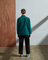 Full-length rear view of model wearing #3001, 'super green' organic cotton over shirt with reinforced elbows.