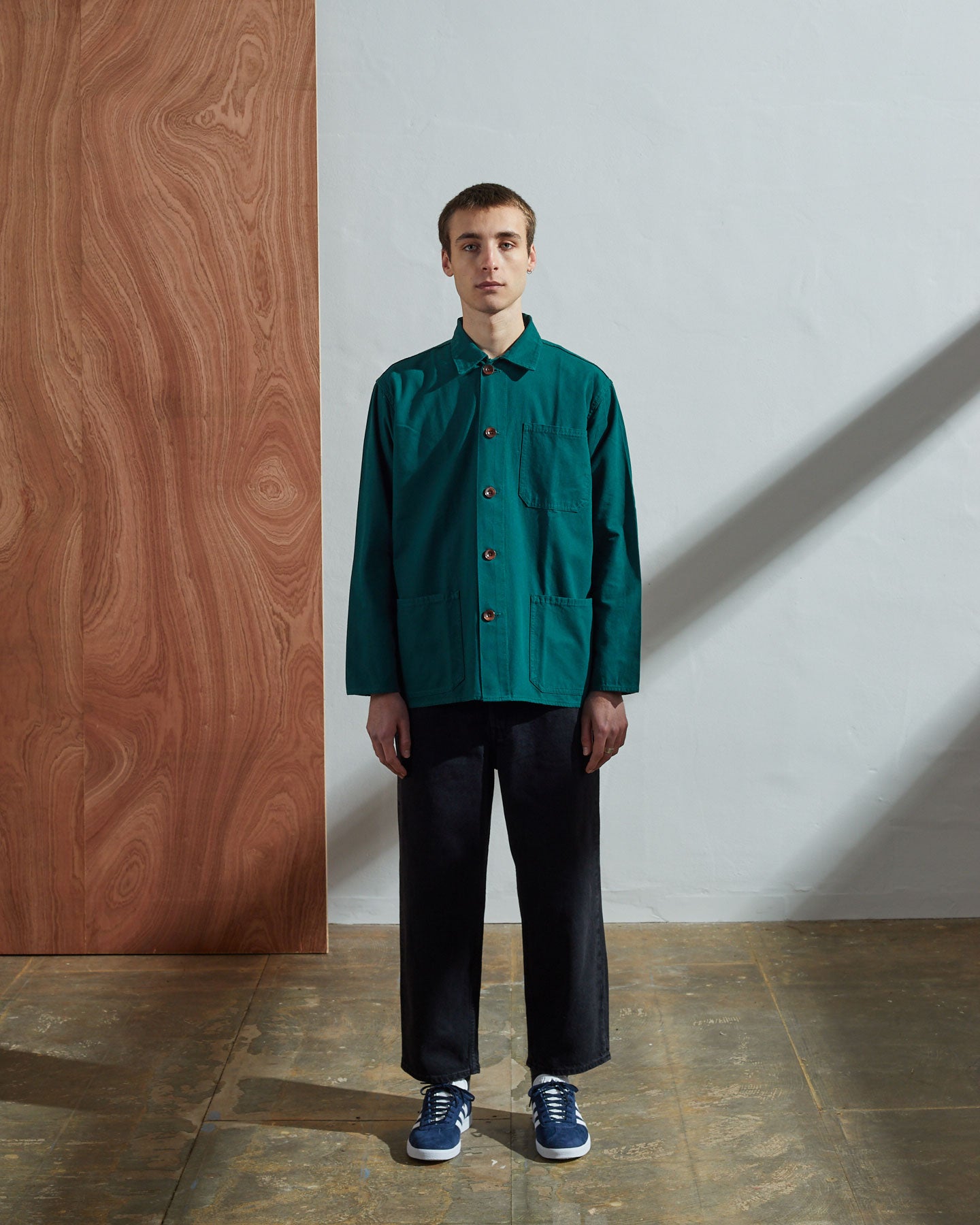 Full-length front view of model wearing #3001, super green organic cotton overshirt paired with dark pants.