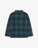 Back view of peacock blue check, buttoned Pennine wool overshirt with view of reinforced elbow area and boxy silhouette.