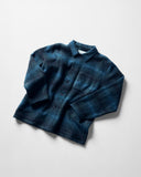 Angled and ruffled flat shot of peacock blue check, buttoned Pennine wool overshirt.