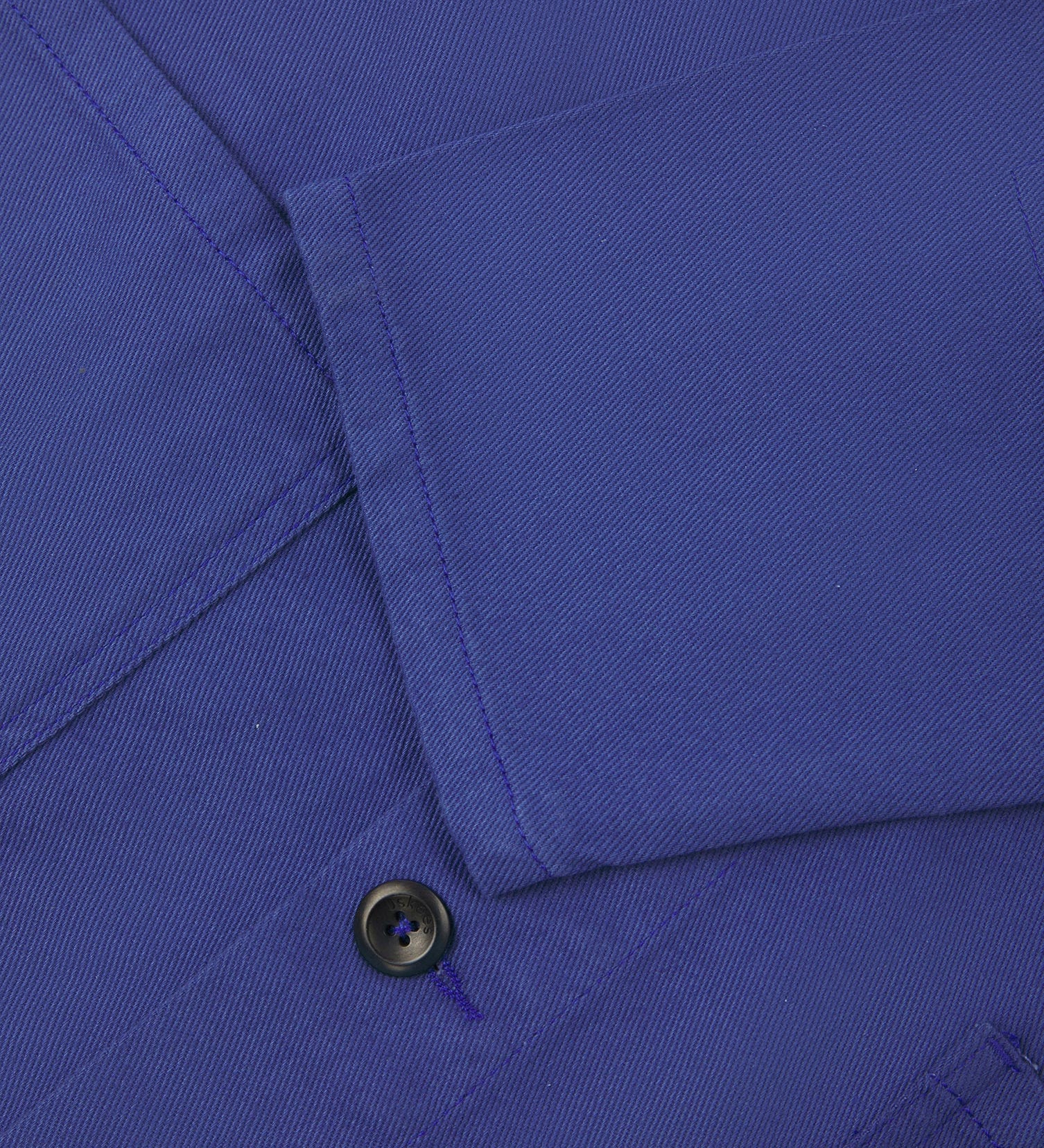 View of the mid-section and sleeve of the 3001 Uskees button-down drill overshirt in ultra blue with focus on cuff, placket and hip pocket.