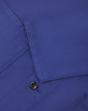 View of the mid-section and sleeve of the 3001 Uskees button-down drill overshirt in ultra blue with focus on cuff, placket and hip pocket.