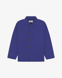 Front flat shot of ultra blue, buttoned organic cotton overshirt. Clear view of chest and hip pockets, corozo buttons and Uskees branding label.