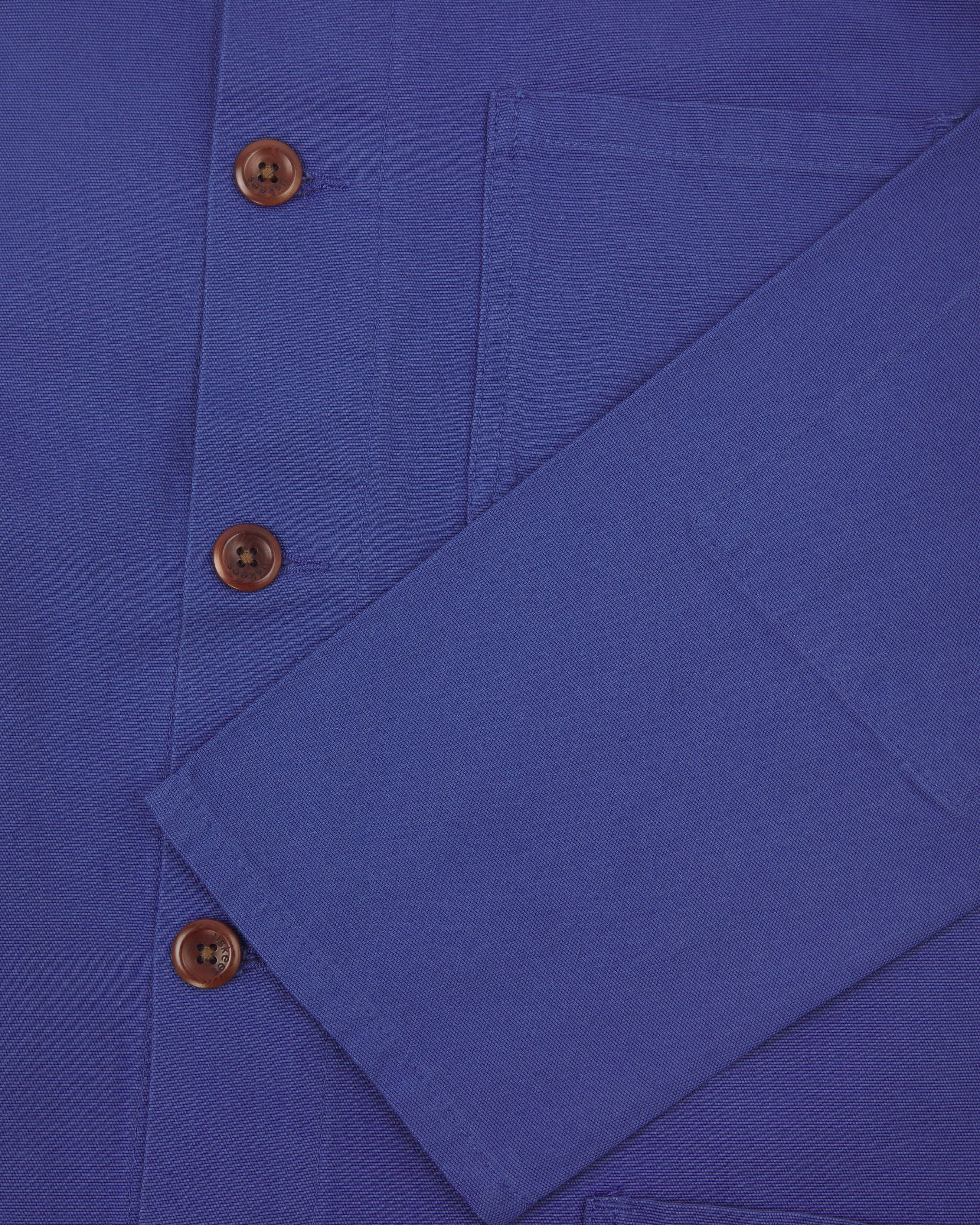 Front close-up flat shot of an uskees bright blue men's overshirt showing brown corozo buttons and sleeve/cuff detail.