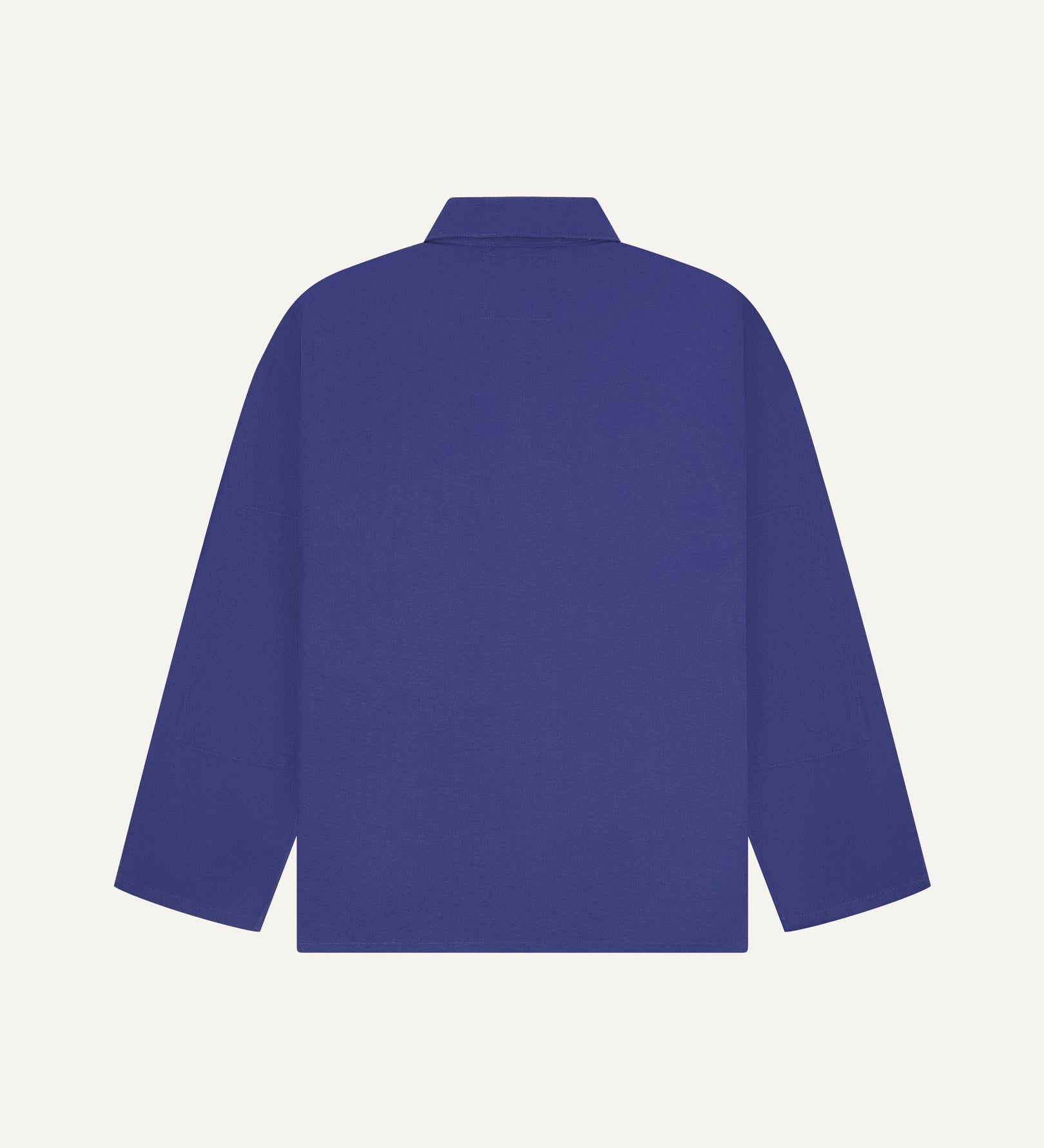 Back view of ultra blue, buttoned organic cotton overshirt with view of reinforced elbow area and boxy silhouette.