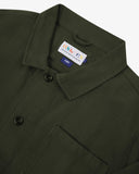 Close-up top-half view of #3001 vine green organic cotton drill overshirt. With focus on collar, Uskees brand label and corozo buttons.