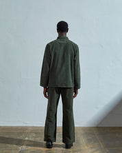 Full-length rear view of model wearing #3001, 'vine green' corduroy over shirt with reinforced elbows.