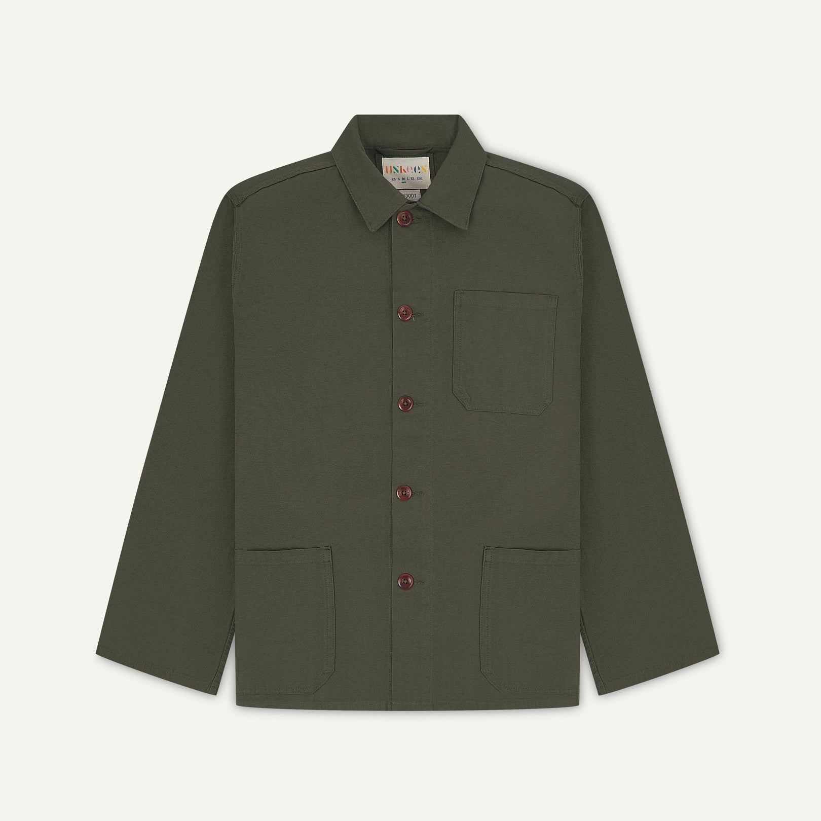 Front flat shot of vine green, buttoned organic cotton overshirt. Clear view of chest and hip pockets, corozo buttons and Uskees branding label.