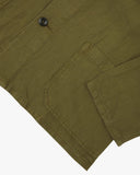 The 3001 Uskees button-down linen blend overshirt in khaki-green, with focus on the cuff, hip pocket, reinforced elbow and corozo buttons.