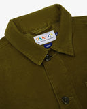 Close-up top-half view of #3001 woodland green organic cotton corduroy overshirt. With focus on collar, hanging loop, Uskees brand label and corozo buttons.