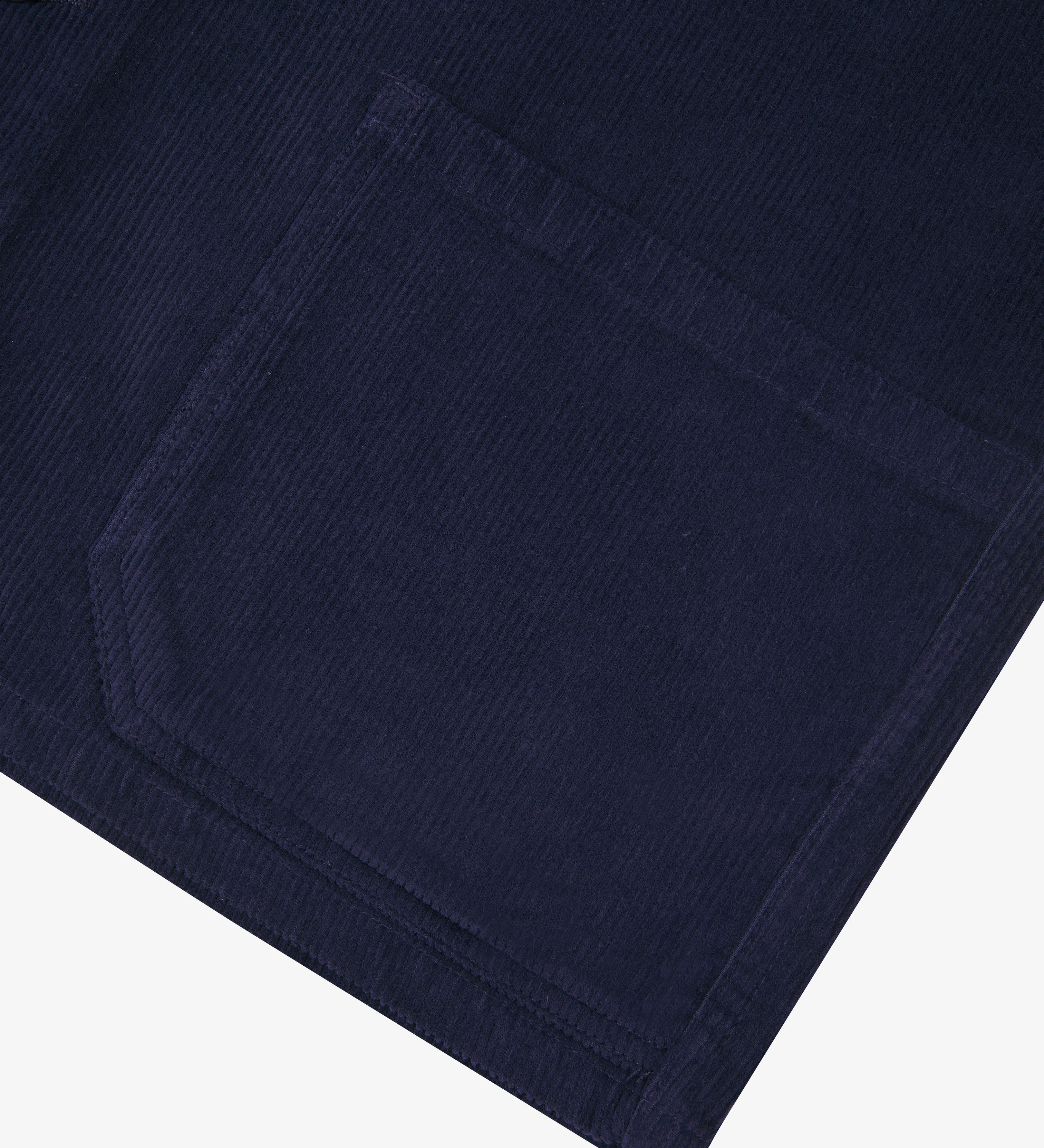 Dark blue corduroy overshirt pocket detail on a white background