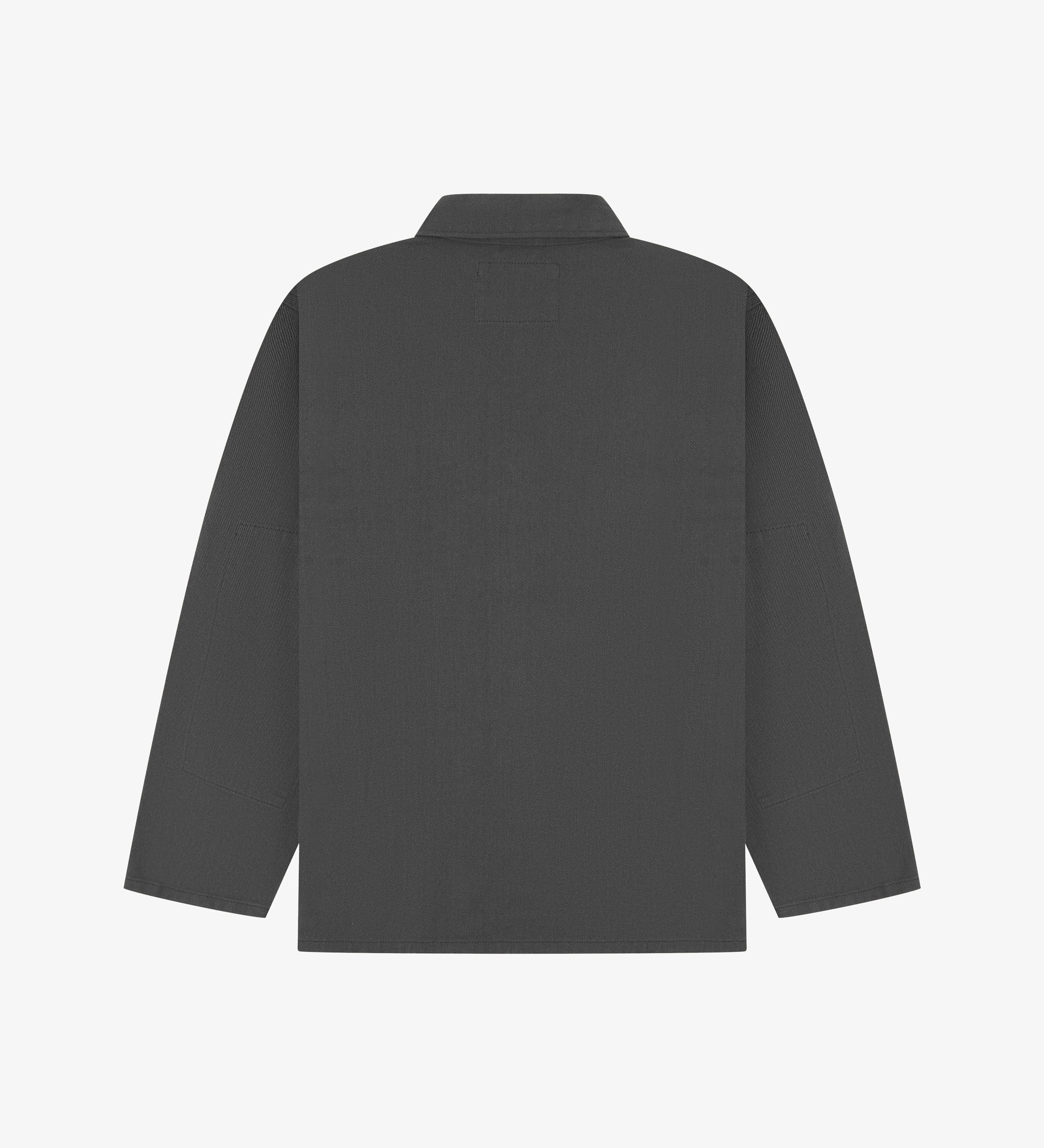 Reverse of charcoal-grey buttoned organic cotton drill overshirt from Uskees. Showing reinforced elbows and boxy silhouette.
