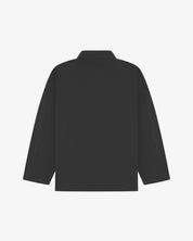 Back view of charcoal-grey, buttoned organic cotton overshirt with view of reinforced elbow area and boxy silhouette.