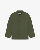 Front flat shot of coriander-green, buttoned organic cotton overshirt. Clear view of chest and hip pockets, corozo buttons and Uskees branding label.