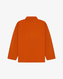 Back view of golden-orange, buttoned organic cotton overshirt with view of reinforced elbow area and boxy silhouette.
