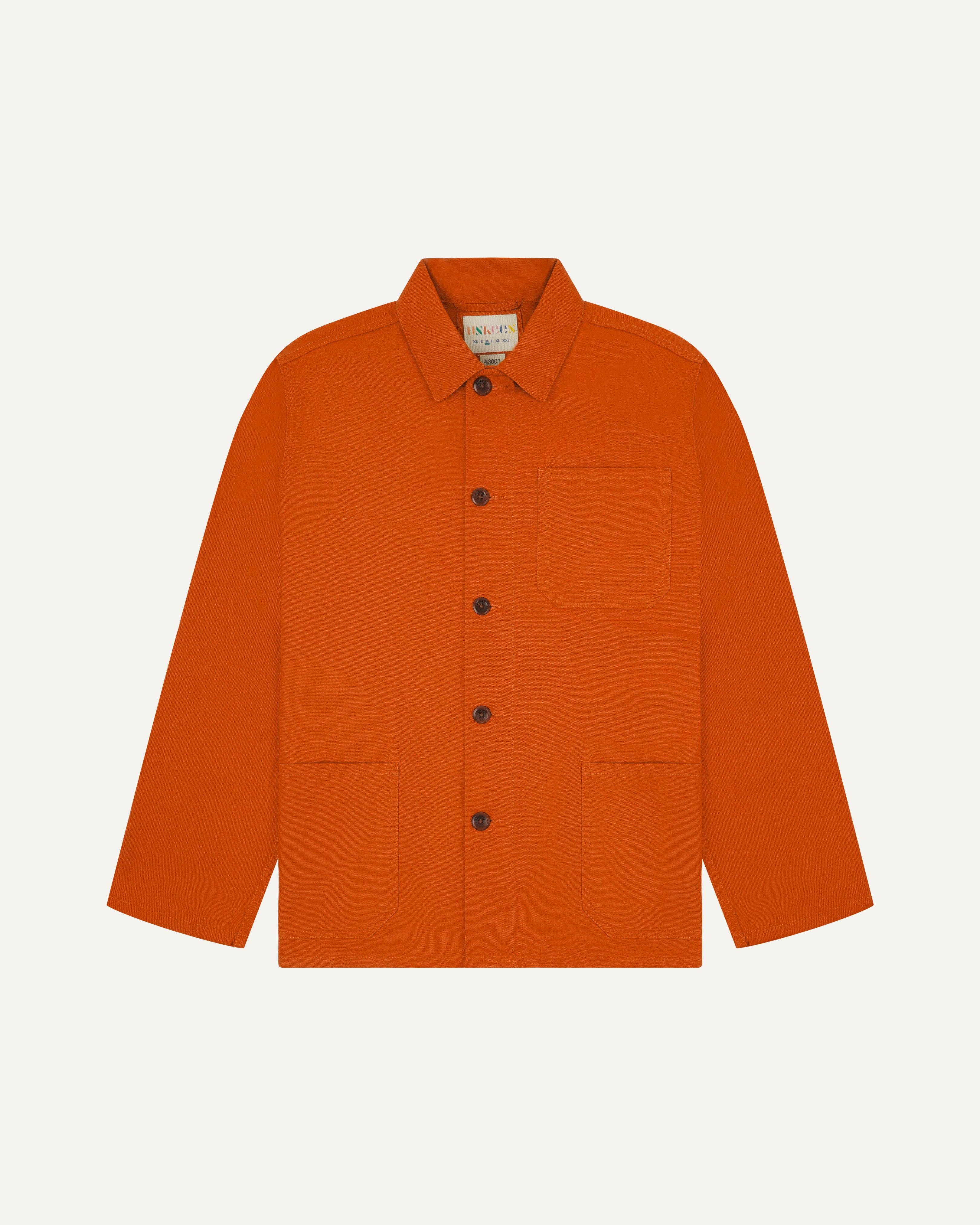 Front flat shot of an uskees orange men's overshirt showing contrast brown corozo buttons and brand label at neck.