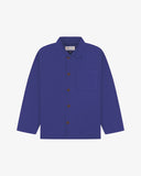 Front flat shot of ultra blue, buttoned organic cotton overshirt. Clear view of chest and hip pockets, corozo buttons and Uskees branding label.