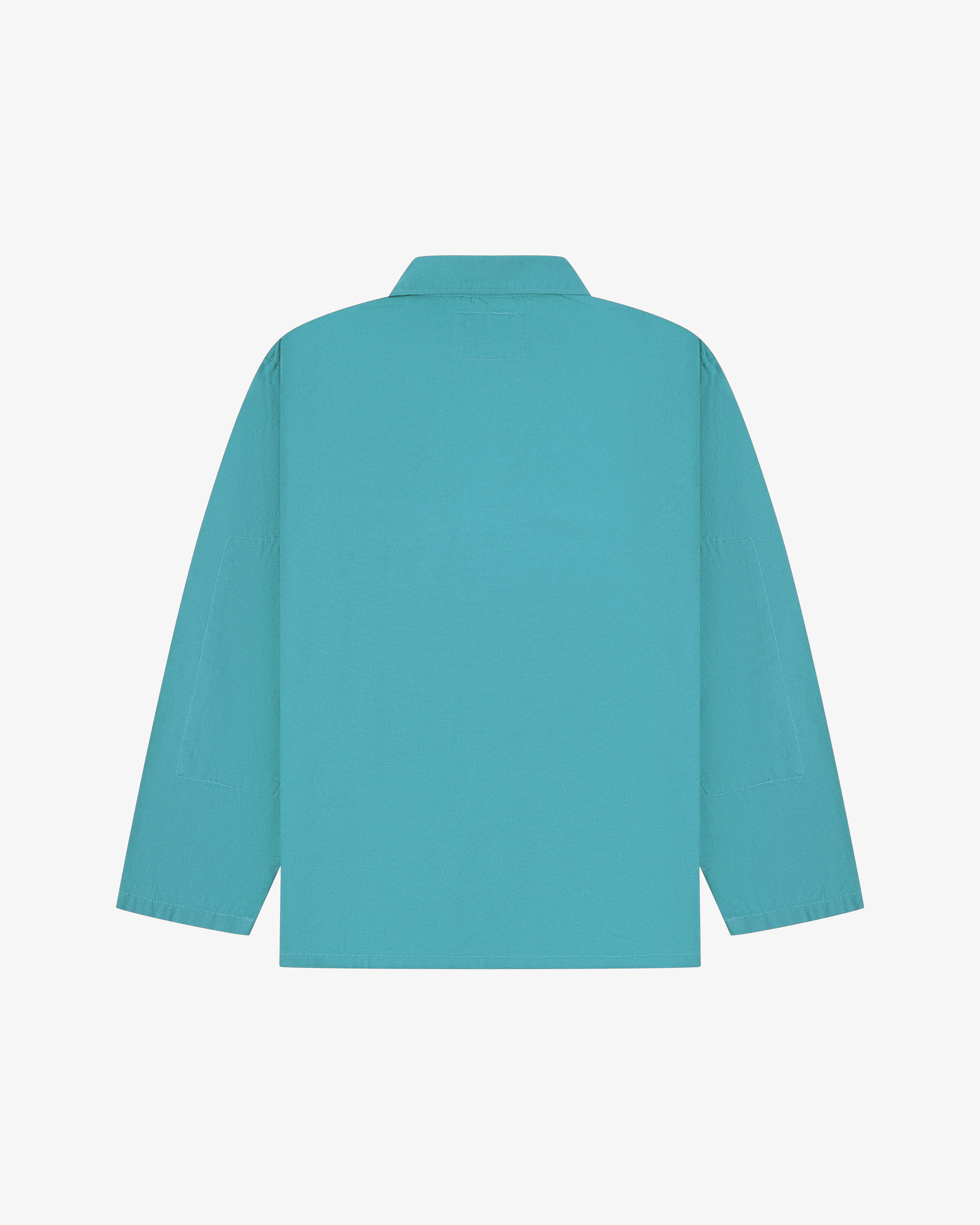 Back flat view of an aqua blue overshirt on a light gray background