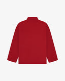 Back view of berry red, buttoned organic cotton overshirt with view of reinforced elbow area and boxy silhouette.
