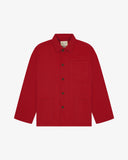 Front flat shot of berry red, buttoned organic cotton overshirt. Clear view of chest and hip pockets, corozo buttons and simple, boxy shape.