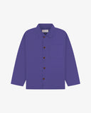 Front flat shot of an Uskees purple shirt jacket with brown Corozo buttons on a light gray background