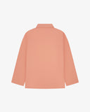 Back view of pink-orange (coral), buttoned organic cotton overshirt with view of reinforced elbow area and boxy silhouette.