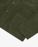 Close up view of an Uskees green corduroy shirt-jacket for men showing button, cuff and pocket detail.