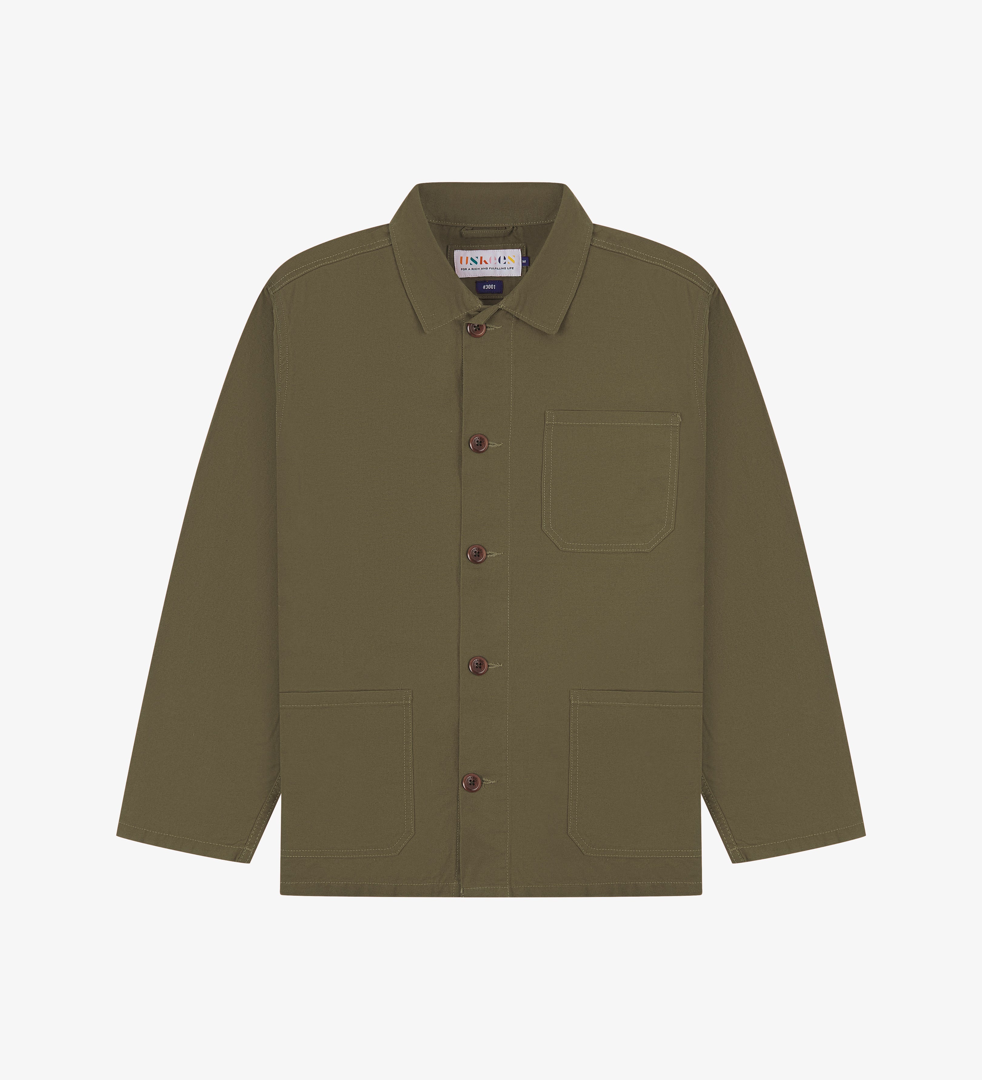 brown shirt showing the Uskees brand label, collar and 3 front pockets on a white background.