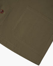 Close-up of a 3001 Uskees dark taupe overshirt pocket with stitching detail on a white background