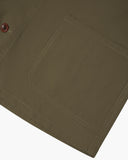 Close-up of a 3001 Uskees dark taupe overshirt pocket with stitching detail on a white background