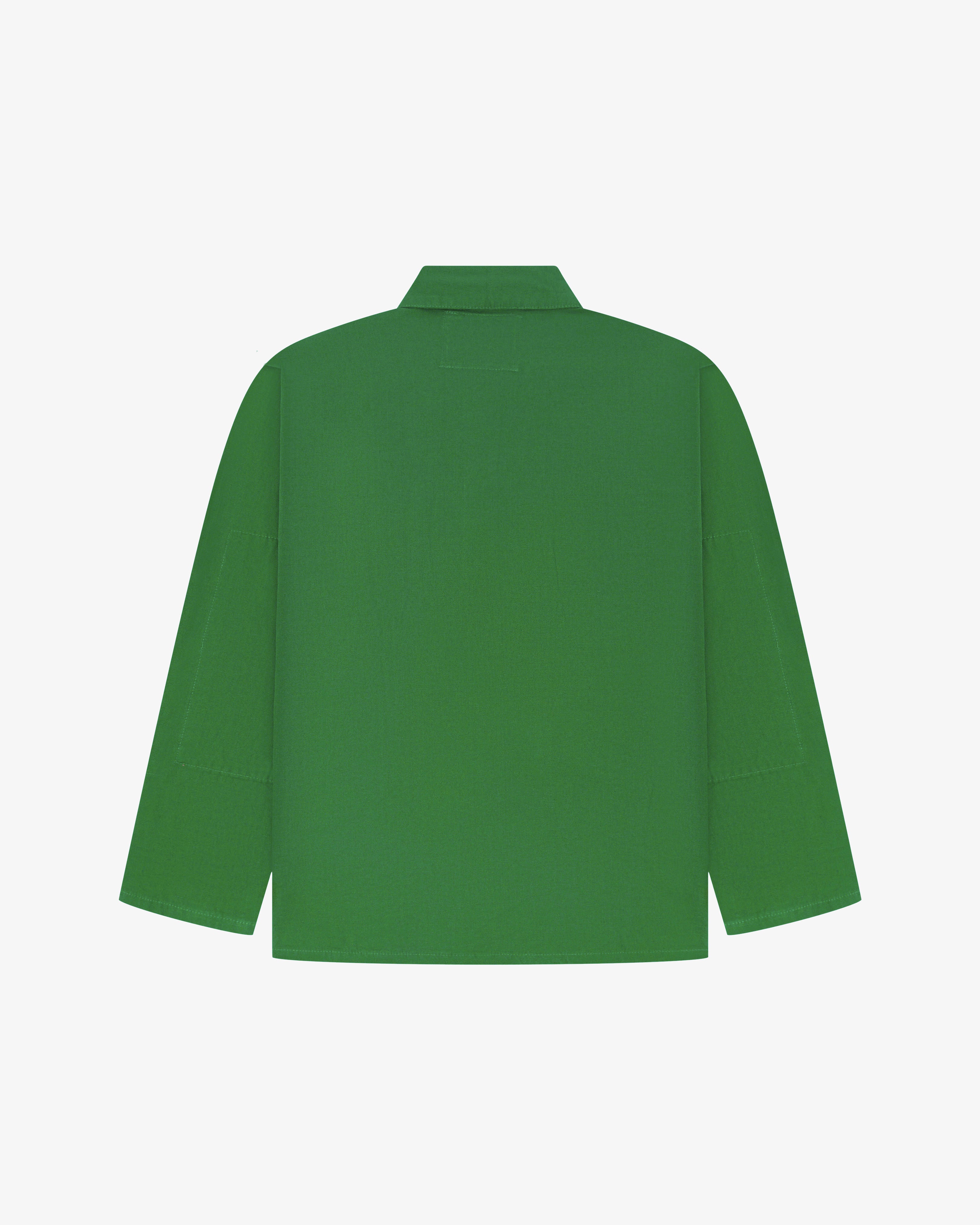 Back view of mint green, buttoned organic cotton overshirt with view of reinforced elbow area and boxy silhouette.