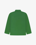 Back view of mint green, buttoned organic cotton overshirt with view of reinforced elbow area and boxy silhouette.