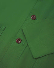 Closer view of mid section of mint green, buttoned organic cotton overshirt from Uskees. Focus on cuff, placket and corozo buttons.