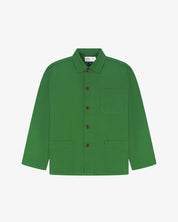 Front flat view of mint green, buttoned organic cotton overshirt. Clear view of chest and hip pockets, branding label, corozo buttons and simple, boxy profile.