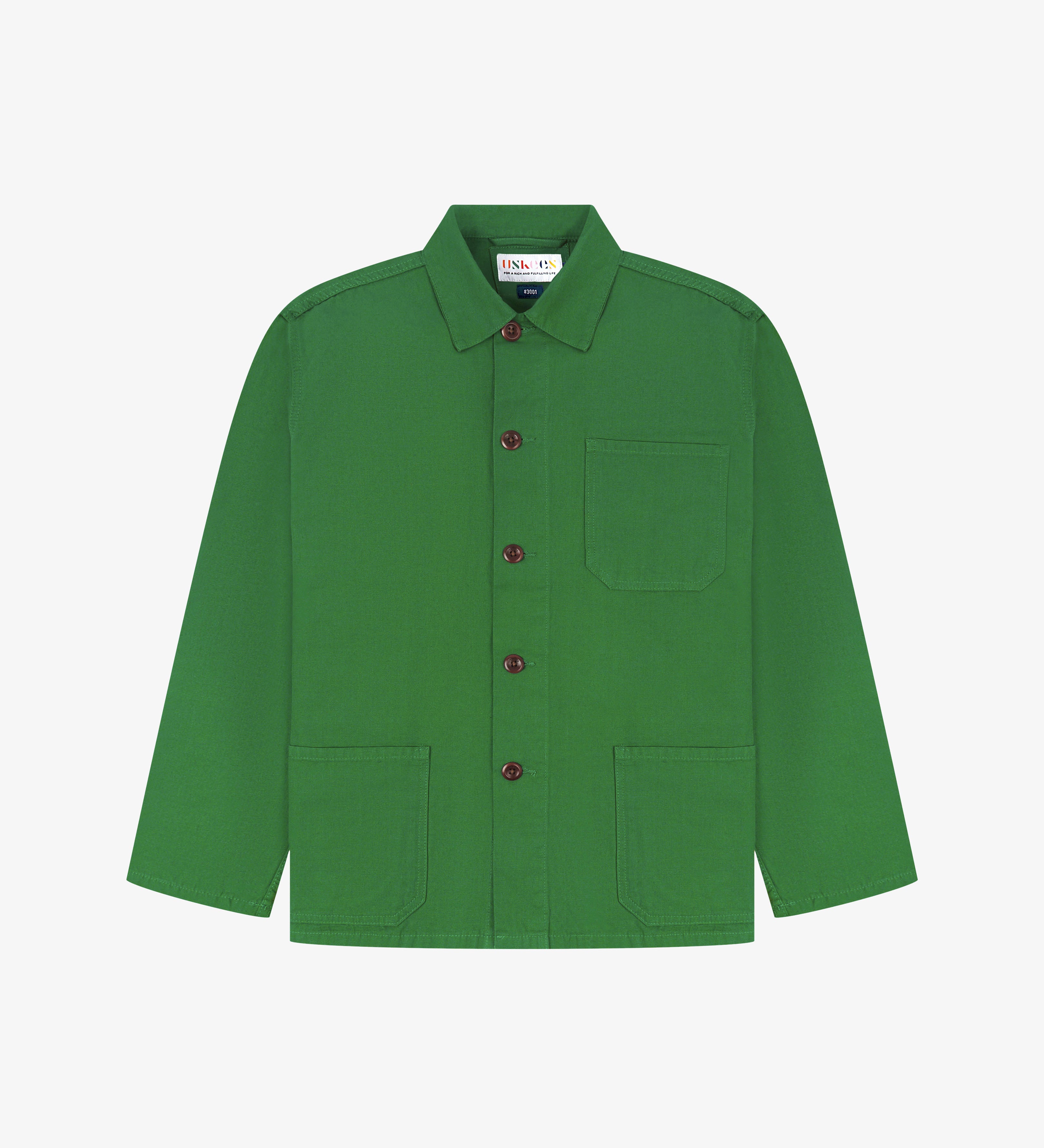 Front flat view of mint green, buttoned organic cotton overshirt. Clear view of chest and hip pockets, branding label, corozo buttons and simple, boxy profile.