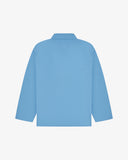 Back view of an Uskees light blue shirt on a white background