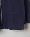 Close-up of organic cotton, #3002 midnight blue zip jacket focussing on the hip pocket.