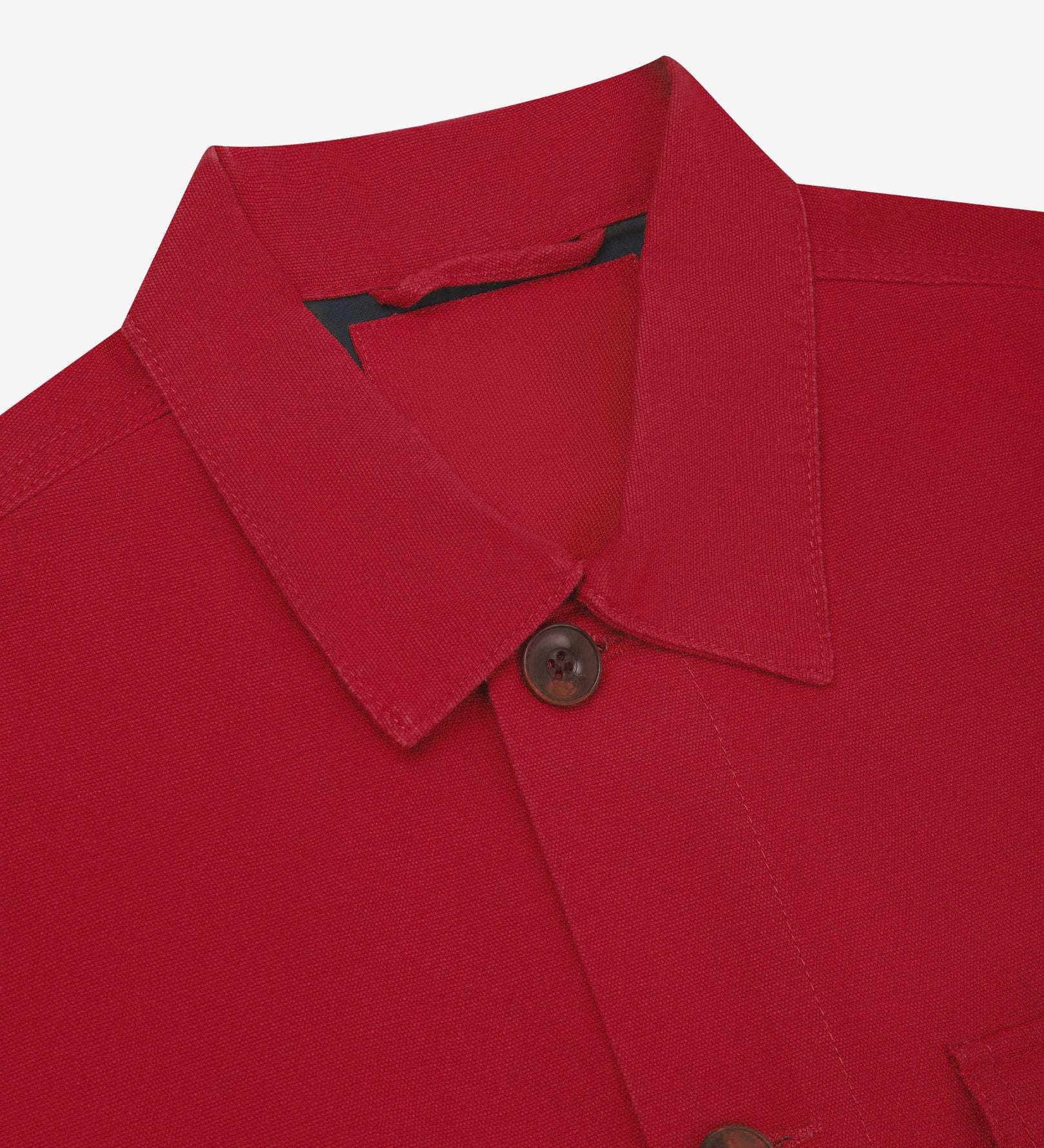 Close-up top-half view of #3003, berry red organic cotton workshirt. With focus on collar, Uskees brand label and corozo buttons.