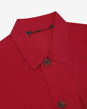 Close-up top-half view of #3003, berry red organic cotton workshirt. With focus on collar, Uskees brand label and corozo buttons.