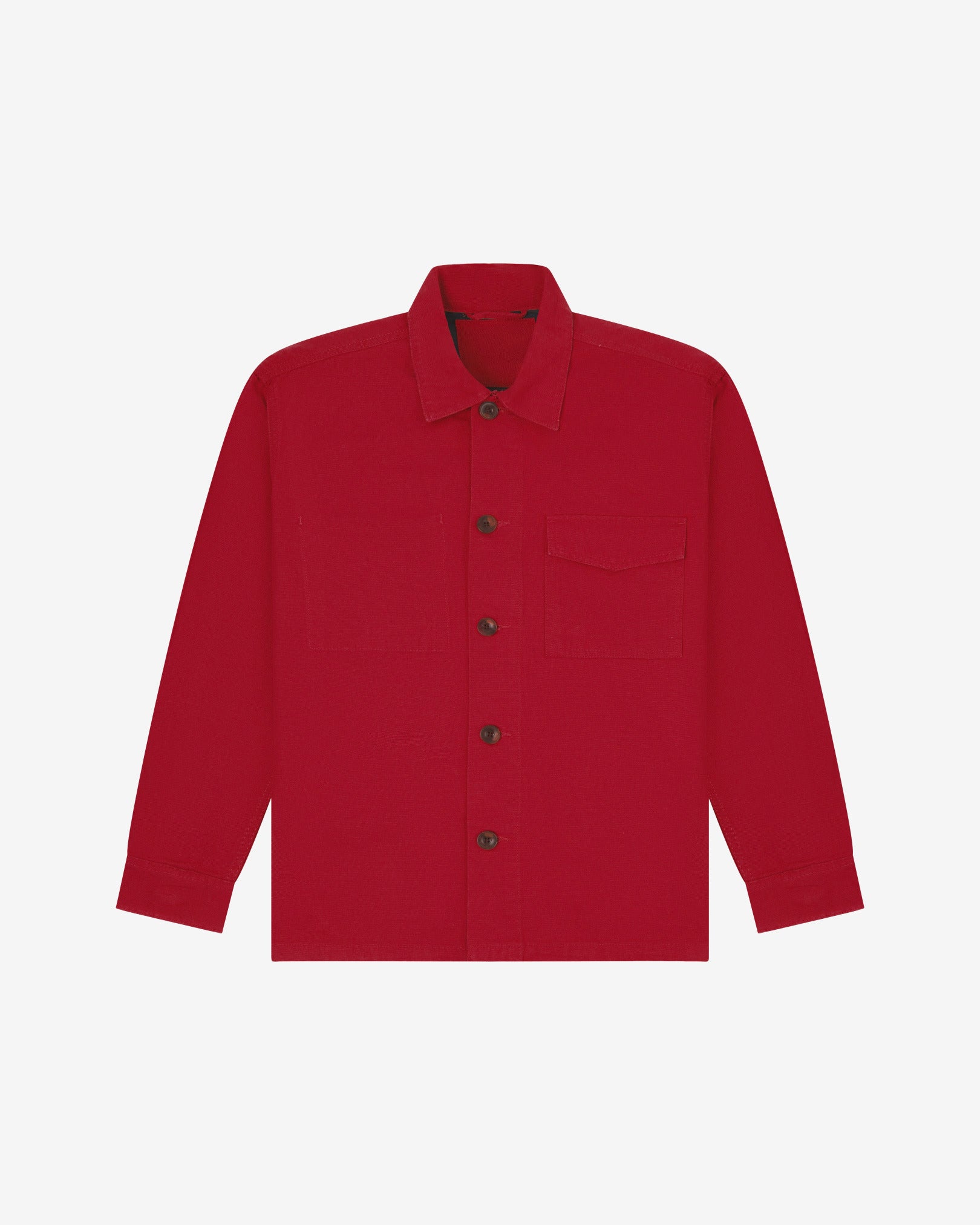 Berry red buttoned organic cotton workshirt from Uskees with clear view of chest pocket and utilitarian silhouette.