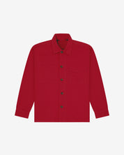 Berry red buttoned organic cotton workshirt from Uskees with clear view of chest pocket and utilitarian silhouette.